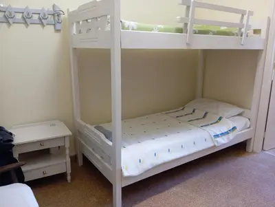 a bedroom with two bunk beds and a table at Bunk bed in dorm 5' from metro in Athens