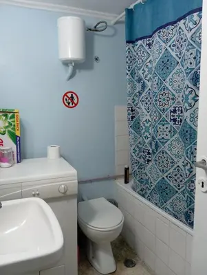 a bathroom with a toilet and a shower curtain at Bunk bed in dorm 5' from metro in Athens