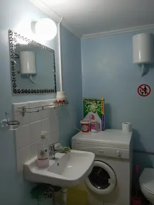 a bathroom with a sink and a toilet at Bunk bed in dorm 5' from metro in Athens