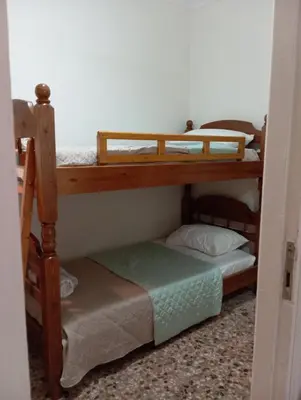 a couple of bunk beds in a room at Wooden bunk bed in a dorm 5' from metro in Athens