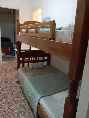 a couple of bunk beds in a room at Wooden bunk bed in a dorm 5' from metro in Athens