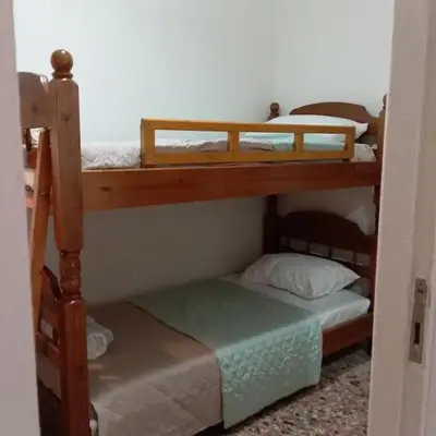 Wooden bunk bed in a dorm 5' from metro