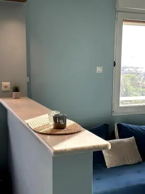 a kitchen counter with a coffee cup on top of it at Flat by the Beach Voula in Athens