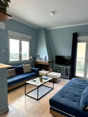 a living room with a couch and a table at Flat by the Beach Voula in Athens