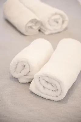 two rolls of white towels on a table at Estia in Athens