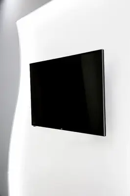 a flat screen tv hanging on a white wall at Estia in Athens
