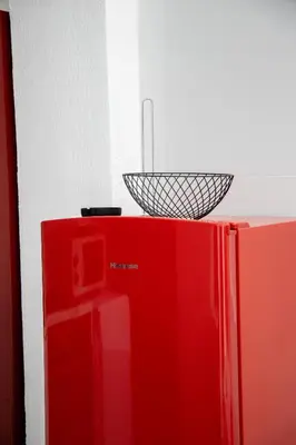 a red refrigerator with a basket on top of it at Estia in Athens