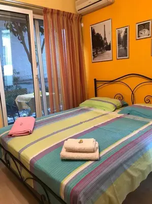 a bed with two towels sitting on top of it at Cozy ground floor studio near metro! in Athens