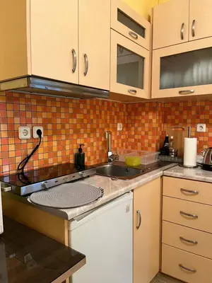 a kitchen with a sink and a counter top at Cozy ground floor studio near metro! in Athens