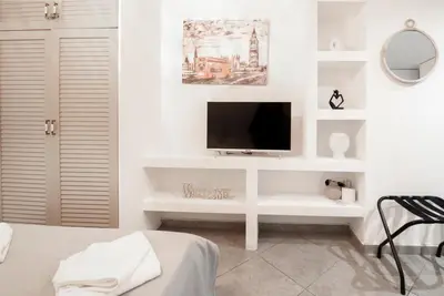 a white room with a tv on a white wall at Ifigenia in Athens