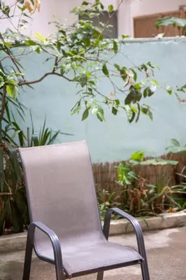 a chair sitting in front of a blue wall at Ifigenia in Athens