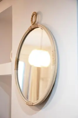a round mirror hanging on a wall at Ifigenia in Athens