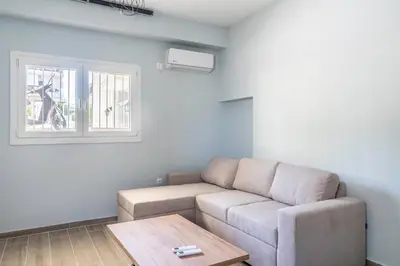 a living room with a couch and a table at Andre Apartment in Athens