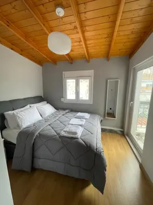 a bedroom with a large bed with a wooden ceiling at Exarcheia Athens Penthouse in Athens