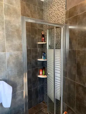 a shower with a glass door in a bathroom at Exarcheia Athens Penthouse in Athens