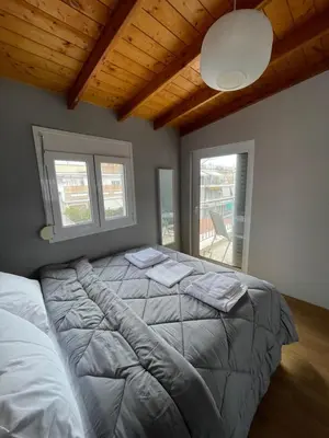 a bedroom with a large bed with two pillows on it at Exarcheia Athens Penthouse in Athens