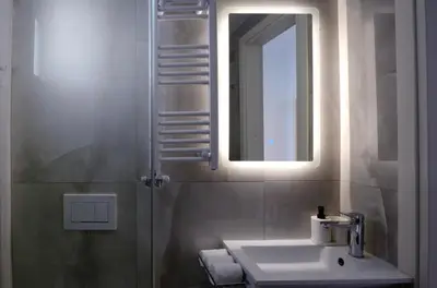 a bathroom with a sink and a mirror at White & Stars in Athens
