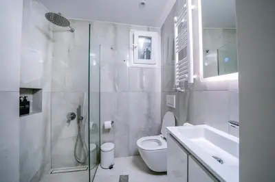 a white bathroom with a toilet and a sink at White & Stars in Athens