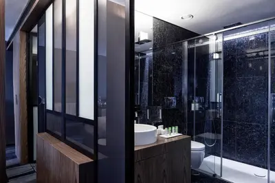 a bathroom with a shower and a sink and a toilet at AthensWas Design Hotel in Athens