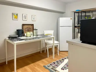 a kitchen with a table and a white refrigerator at Athens Center, Akadimias 77 - 1rst floor in Athens