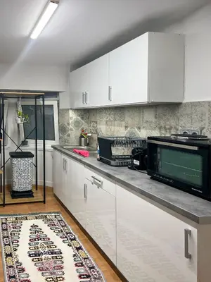 a kitchen with white cabinets and a microwave at Athens Center, Akadimias 77 - 1rst floor in Athens