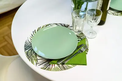 a white table with a plate and glasses on it at Palm Athens by GK Properties in Athens