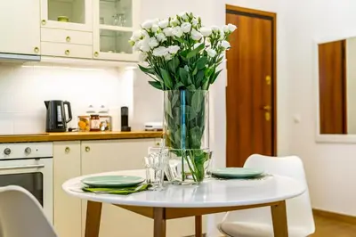 a vase of flowers on a table in a kitchen at Palm Athens by GK Properties in Athens