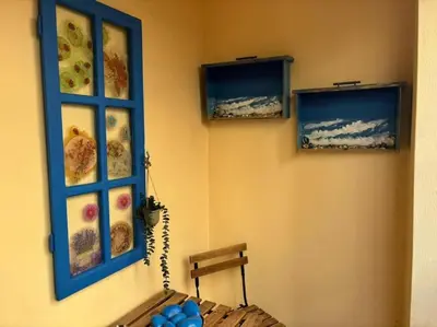 a room with two pictures on the wall at Thissio Gazi apartment with private parking in Athens