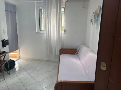 a small room with a couch and a window at Thissio Gazi apartment with private parking in Athens