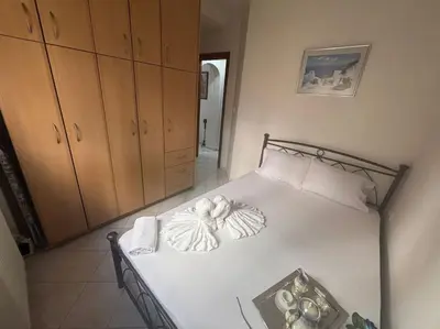 a bedroom with a white bed with towels on it at Thissio Gazi apartment with private parking in Athens