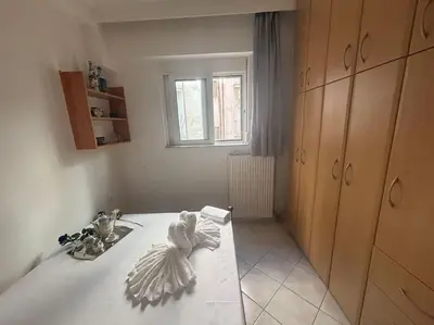 a room with a bed and a window at Thissio Gazi apartment with private parking in Athens