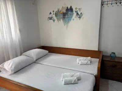 a bedroom with a bed with two towels on it at Thissio Gazi apartment with private parking in Athens