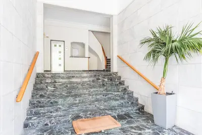 a staircase with a potted plant in a house at Modern spacious apt in Athens in Athens