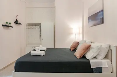 a bedroom with a large bed with pillows on it at Alice Museum Retreat in Athens