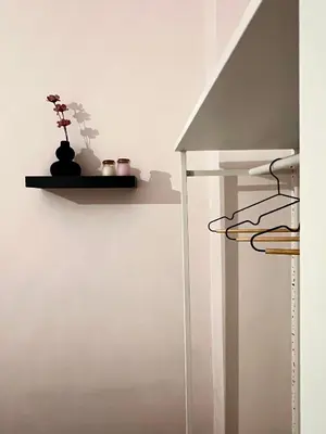 a room with a shelf with a plant on a wall at Alice Museum Retreat in Athens