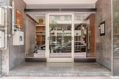 a glass door of a store with a car in it at Alice Museum Retreat in Athens