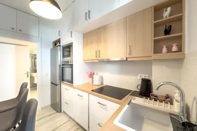 a kitchen with white cabinets and a sink at Maya's Apt near Athens center in Athens