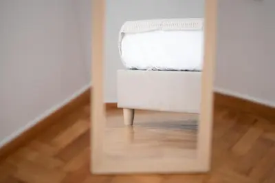 a mirror reflection of a bed in a bedroom at Eclectic Moonstone apartment in Athens in Athens