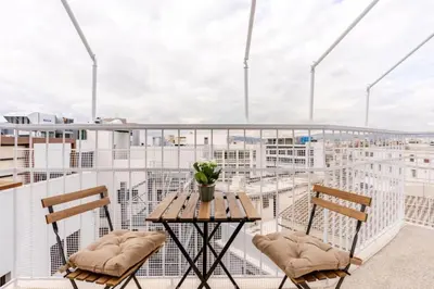 a balcony with a table and two chairs at Athens City Center Gem-Acropolis View-Bright Spacious Flat in Athens