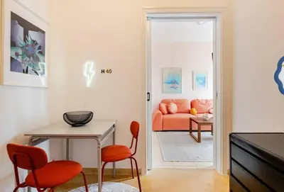 a living room with orange chairs and a couch at Athens City Center Gem-Acropolis View-Bright Spacious Flat in Athens