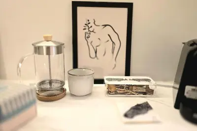 a table with a blender and a picture of a horse at Pangrati Muse Loft Athens in Athens