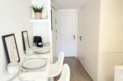 a white bathroom with a sink and two mirrors at Pangrati Muse Loft Athens in Athens