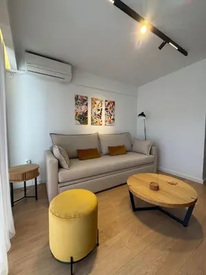 a living room with a couch and a table at Pangrati Muse Loft Athens in Athens