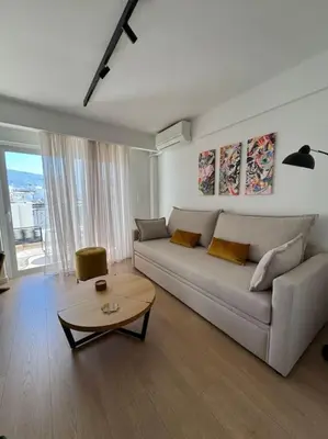 a living room with a couch and a table at Pangrati Muse Loft Athens in Athens