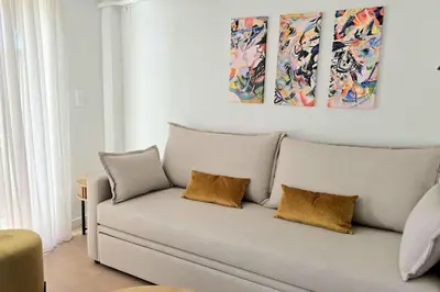 a couch with two pillows in a living room at Pangrati Muse Loft Athens in Athens