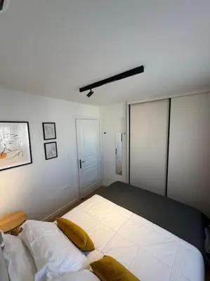 a bedroom with a large bed with yellow pillows at Pangrati Muse Loft Athens in Athens