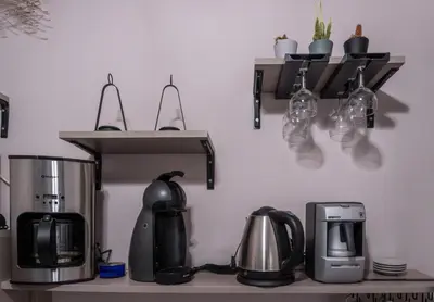 a kitchen counter with a coffee maker and a coffee pot at akinitapanou in Athens