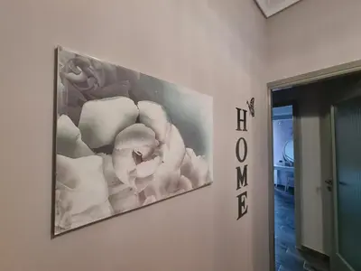 a painting hanging on a wall in a room at akinitapanou in Athens