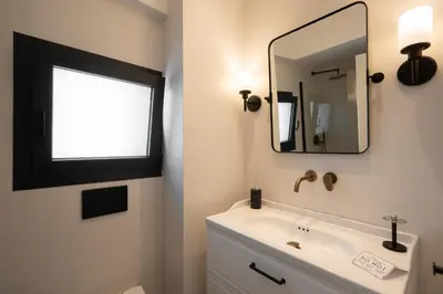 a bathroom with a sink and a mirror at Luxury Petralona Penthouse - Sleeps 7 -Near Metro in Athens