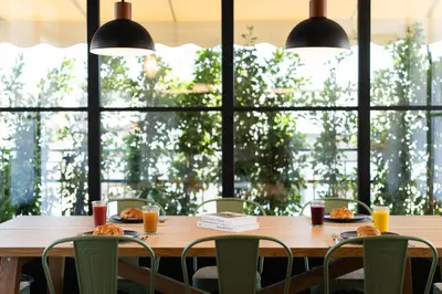 a table in a restaurant with food and drinks at Luxury Petralona Penthouse - Sleeps 7 -Near Metro in Athens